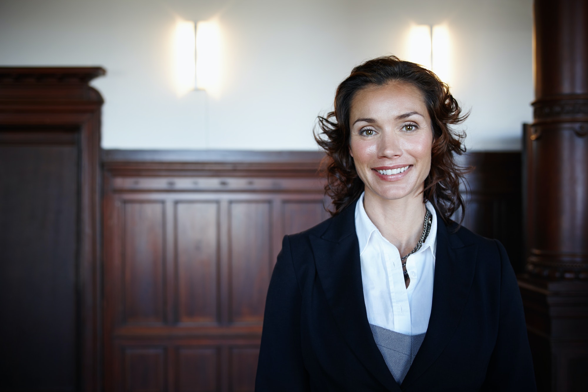 Cropped shot of an attractive mature female lawyer standing in a courtroom and smiling