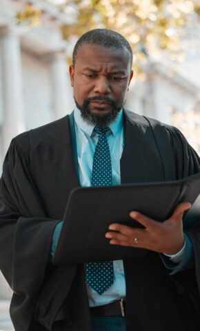 Reading up a bit more. Shot of a mature male lawyer preparing for court in the city.